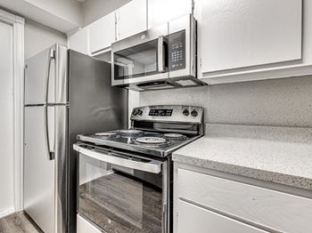 a kitchen with stainless steel appliances and white cabinets at Diamond Ridge Townhomes, Oklahoma City Oklahoma